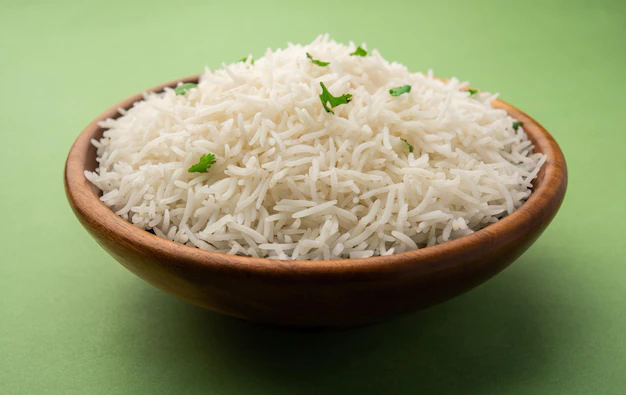 A bowl of cooked basmati rice garnished with coriander leaves